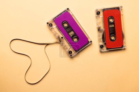 Photo for Overhead view of two colourful cassette tapes on beige background. Music, sound, listening, entertainment and nostalgia concept. - Royalty Free Image