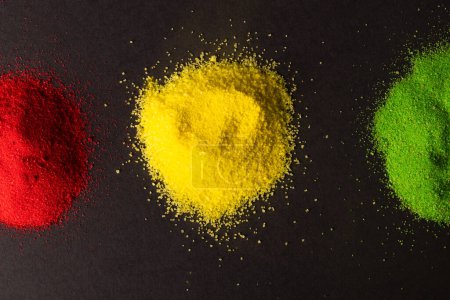 Photo for Green, yellow and red powders with copy space on black background. Black history month, africa, black culture and history concept. - Royalty Free Image