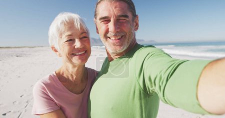 Photo for Image of senior woman and her husband on beach. digital interface, social media and global network concept digitally generated image. - Royalty Free Image