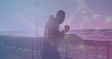 Photo for Plexus networks against african american fit man practising boxing while running on the promenade. sports, fitness and technology concept - Royalty Free Image