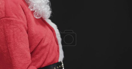 Téléchargez les photos : Détail du costume du Père Noël, avec espace de copie. Costume rouge et barbe blanche évoquent l'esprit des fêtes à la maison. - en image libre de droit