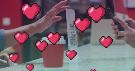 Téléchargez les photos : Plusieurs icônes roses flottent contre une personne effectuant un paiement via un smartphone dans un café. paiement numérique et concept technologique - en image libre de droit