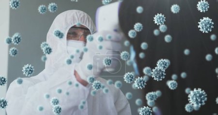 Photo for Image of floating covid-19 cells with man checking temperature wearing face masks. Healthcare and protection during coronavirus covid 19 pandemic, digitally generated image - Royalty Free Image