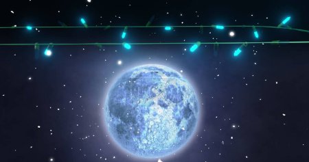 Téléchargez les photos : Des lumières bleues de Noël clignotent sur la neige tombante et la pleine lune dans le ciel nocturne. Noël, décorations, tradition et célébration image générée numériquement. - en image libre de droit