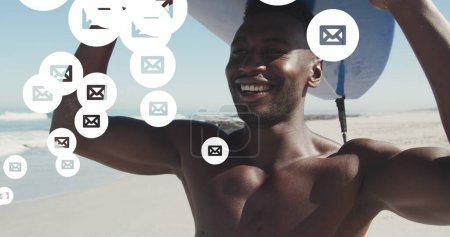 Téléchargez les photos : Multiple message icons floating against african american man carrying surfboard at the beach. social media networking and vacation concept - en image libre de droit