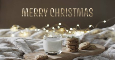 Photo for Merry christmas text over christmas cookies and milk with string lights in background. Christmas, tradition, greetings and celebration digitally generated image. - Royalty Free Image