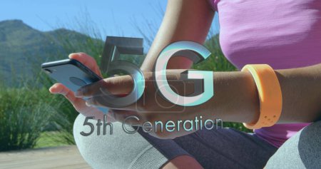 Photo for Image of 5g 5th generation text with globe spinning over woman using smartphone. digital interface global connection and communication concept digitally generated image. - Royalty Free Image