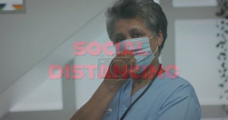Photo for Social distancing text against portrait of african american female doctor lowering her face mask. coronavirus covid 19 pandemic concept - Royalty Free Image