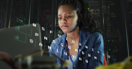 Photo for Image of letters changing over biracial woman working on laptop in server room. network, programming, computers and technology concept digitally generated image. - Royalty Free Image