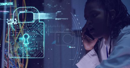 Photo for Image of data processing and padlock over african american woman working in server room. network, programming, computers and technology concept - Royalty Free Image