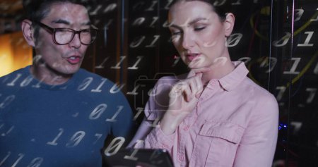 Photo for Image of binary code over diverse woman and man working in server room. network, programming, computers and technology concept digitally generated image. - Royalty Free Image