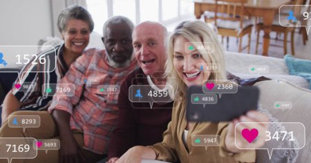 Photo for Image of media icons over diverse group of seniors taking selfie. senior home hangout and digital interface concept digitally generated image. - Royalty Free Image