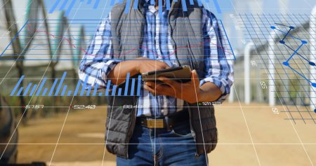 Photo for Image of data processing and statistics over biracial engineer using tablet. Global engineering, digital interface, computing and data processing concept digitally generated image. - Royalty Free Image