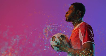 Image of african american male soccer player with ball in hand. Global sport and digital interface concept digitally generated image.