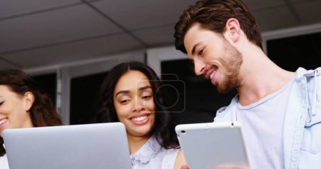 Photo for Young Caucasian woman and man share a moment at the office. They are engaged in a collaborative task, showcasing teamwork in a professional setting. - Royalty Free Image