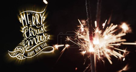 Photo for Image of merry christmas text over lit sparklers background. Christmas, tradition and celebration concept digitally generated image. - Royalty Free Image