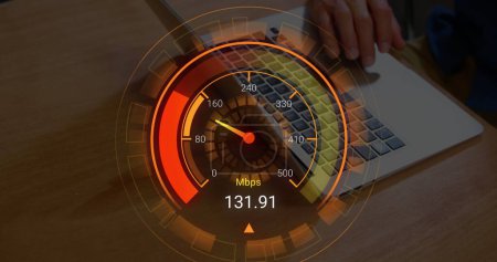 Photo for Image of orange speedometer over hands of biracial man using laptop. Internet speed, transfer, communication and technology concept digitally generated image. - Royalty Free Image