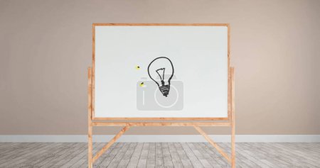 Photo for Digital image of a drawing of a light bulb with yellow lights in a white board with wooden frame inside a room with light pink walls and wooden floor - Royalty Free Image