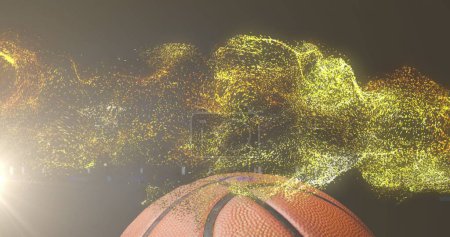 Téléchargez les photos : Image de particules d'or brillantes se déplaçant sur le basket-ball. concept sport et compétition, image générée numériquement. - en image libre de droit
