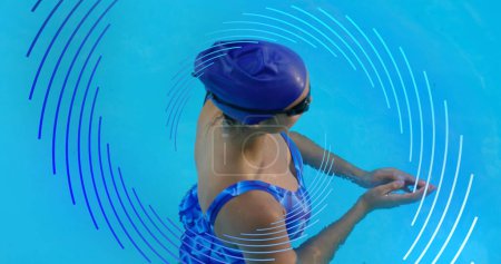 Photo for Image of blue line spiral rotating over woman swimming in pool. sport and fitness concept, digitally generated image. - Royalty Free Image