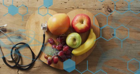 Image of chemical structures over stethoscope and fruits. Global medicine, food and digital interface concept digitally generated image.