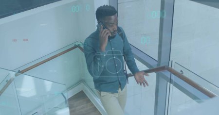 Image of data processing over african american businessman using smartphone. Global business and digital interface concept digitally generated image.