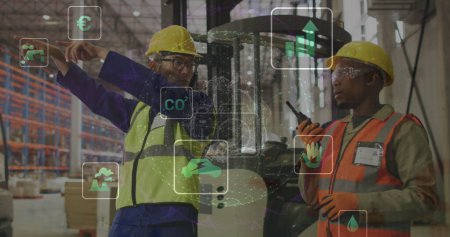 Image of eco icons and data processing over diverse people working in warehouse. Global shipping, business, finance, computing and data processing concept digitally generated image.