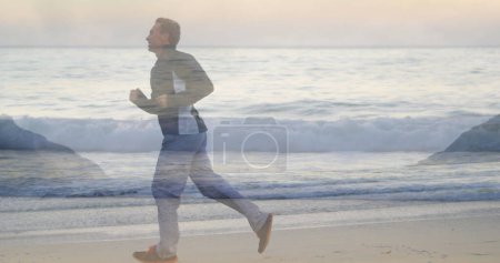 Man running on beach with waves in view.