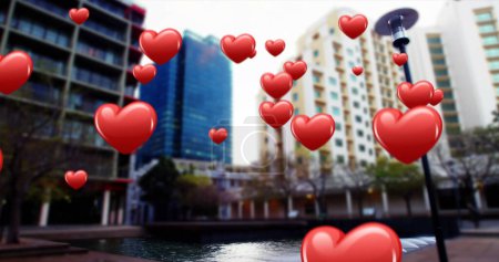 Téléchargez les photos : Icônes de coeur flottant sur un paysage urbain - en image libre de droit