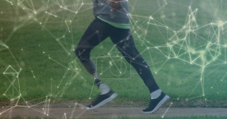 Photo for Image of communication network moving over male athlete with prosthetic leg running outdoors. sport, achievement and communication technology concept, digitally generated image. - Royalty Free Image