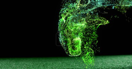 Foto de Imagen de partículas verdes brillantes moviéndose sobre la pelota de rugby en el terreno de juego. concepto de deporte y competición, imagen generada digitalmente. - Imagen libre de derechos