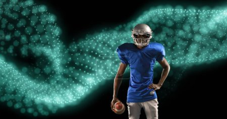 Image of network of glowing particles over male american football player holding ball. sport, competition and technology concept, digitally generated image.