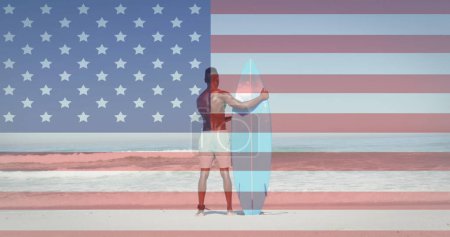 Image of american flag and man with surfboard on beach. usa patriotism, celebration and democracy concept digitally generated image.
