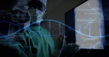 Image of dna strand over diverse surgeons in hospital. Global medicine, healthcare, connections, computing and data processing concept digitally generated image.