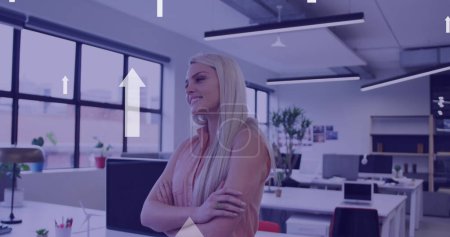 Photo for Image of arrows over caucasian businesswoman smiling in office. global networks, business, data processing and digital interface concept digitally generated image. - Royalty Free Image