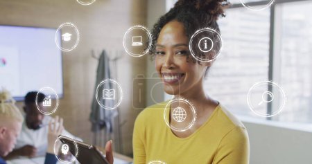 Image of icons and data processing over biracial businesswoman in office. Global business, finances, computing and data processing concept digitally generated image.