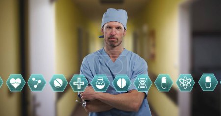 Photo for Multiple medical icons against portrait of caucasian male surgeon standing with arms crossed. medical science and technology concept - Royalty Free Image