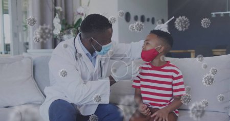 Bild von Viruszellen über afrikanisch-amerikanischen männlichen Arzt Test Junge für covid 19. Medizin und Gesundheitswesen während Coronavirus covid 19 pandemisches Konzept digital generiertes Bild.