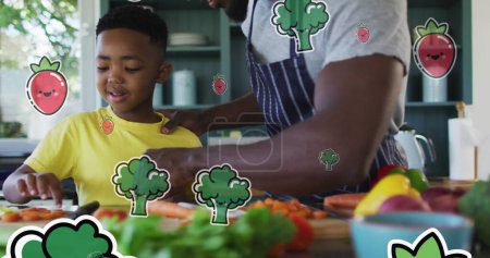Image of vegetables floating over happy african american father and son preparing meal. family, togetherness, spending quality time concept digitally generated image.