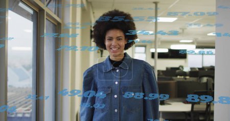 Image of financial data processing over biracial businesswoman in office. Global business, finances, computing and data processing concept digitally generated image.