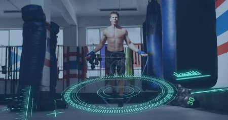 Image of scope scanning and data processing over caucasian man jumping rope at gym. Global sport and digital interface concept digitally generated image.