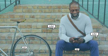 Photo for Image of lol text in speech bubbles over african american man using smartphone. global social networking, communication and connection concept digitally generated image. - Royalty Free Image