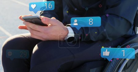 Photo for Image of icons with numbers over disabled cuacasian man sitting in wheelchair using smartphone. International day of persons with disabilities concept digitally generated image. - Royalty Free Image