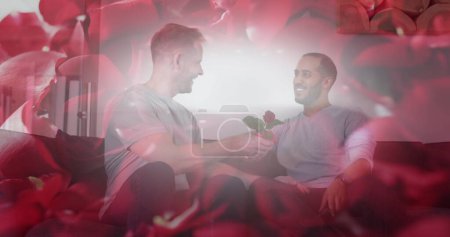 Photo for Diverse gay couple sharing a romantic moment, with copy space. Surrounded by soft rose petals, they celebrate love in an intimate setting. - Royalty Free Image