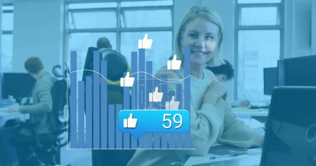 Image of social media reactions and graphs over caucasian woman in office. Social media, communication, business and technology concept digitally generated image.