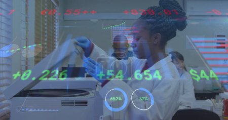 Image of financial data processing over diverse doctors. global medicine, healthcare and technology concept digitally generated image.