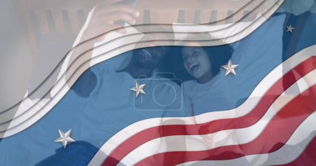 Téléchargez les photos : Image du drapeau des Etats-Unis agitant sur le père afro-américain et sa fille prenant selfie. patriotisme américain, indépendance et concept de célébration image générée numériquement. - en image libre de droit