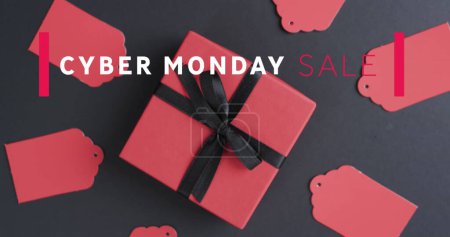 Photo for Image of cyber monday sale text over gift tags and boxes. Sales, retail, cyber shopping, digital interface, communication, computing and data processing concept digitally generated image. - Royalty Free Image