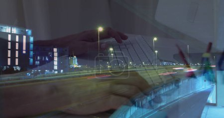 Photo for Image of hands working on laptop over sped up traffic in city at night. business and communication technology concept digitally generated image. - Royalty Free Image