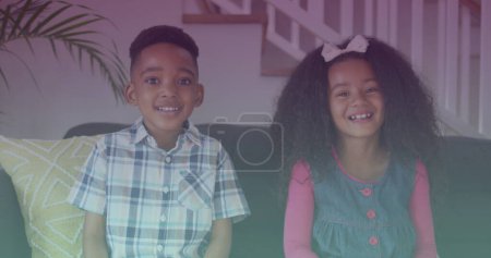 Spots of light against portrait of african american brother and sister smiling sitting on the couch. national siblings day awareness concept